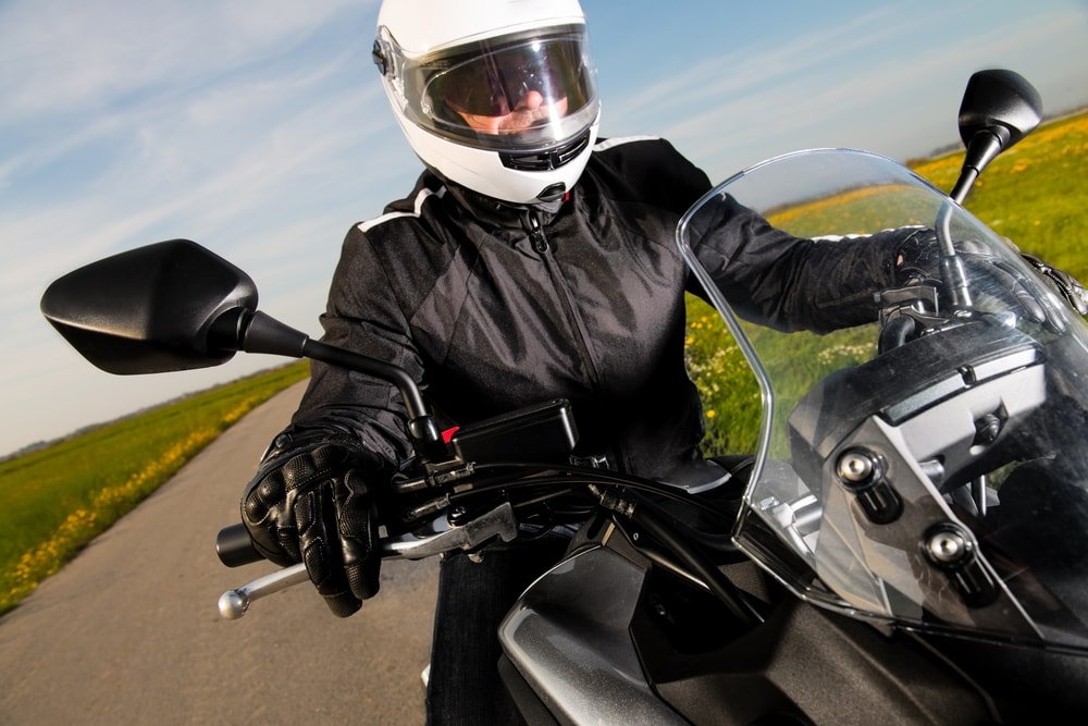 Motorcycle driver on safety gear.