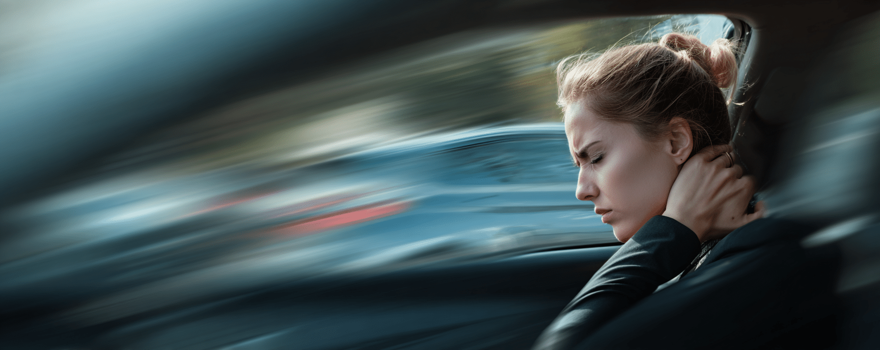 Woman experiencing whiplash pain after a rear-end collision