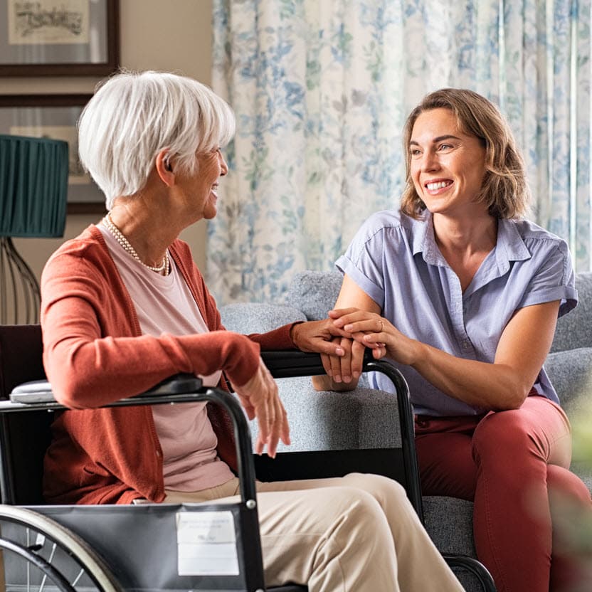 Old woman visiting with her daughter at a nursing home